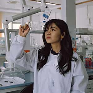 Young Asian Female Science Researcher Holding Vial